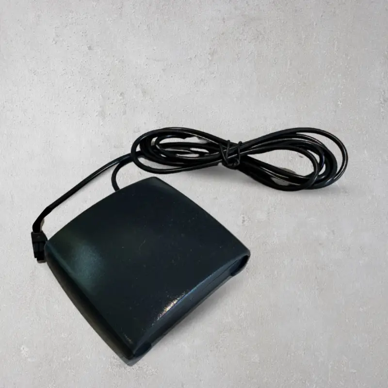 Spapilot smart controller hardware unit with connection cable against concrete background